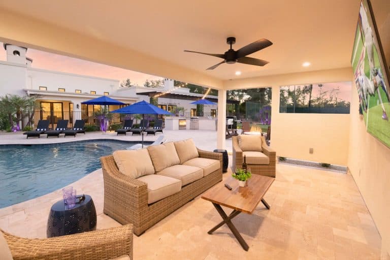 An outdoor sitting area perfect for a destination wedding in Scottsdale, featuring a couch and TV.