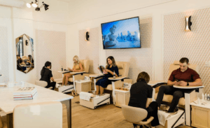 Guests receive pedicure treatments in the bright, modern lounge at Clover Life Spa.
