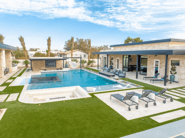 Scottsdale vacation estate with golf simulator, heated pool, water slide, putting green, and luxury entertainment spaces.