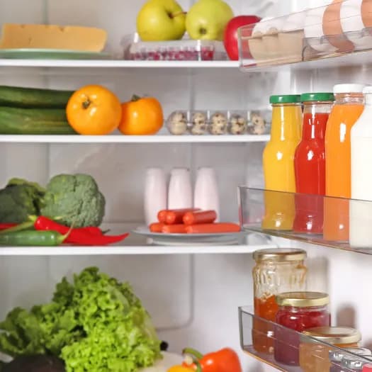A bright, well-stocked refrigerator with fresh produce and groceries.