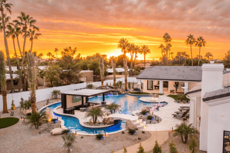 A luxury mansion rental with a lazy river pool in the backyard.