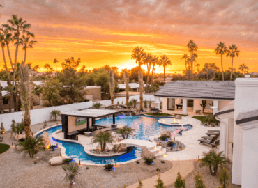 A mansion with a resort style pool.