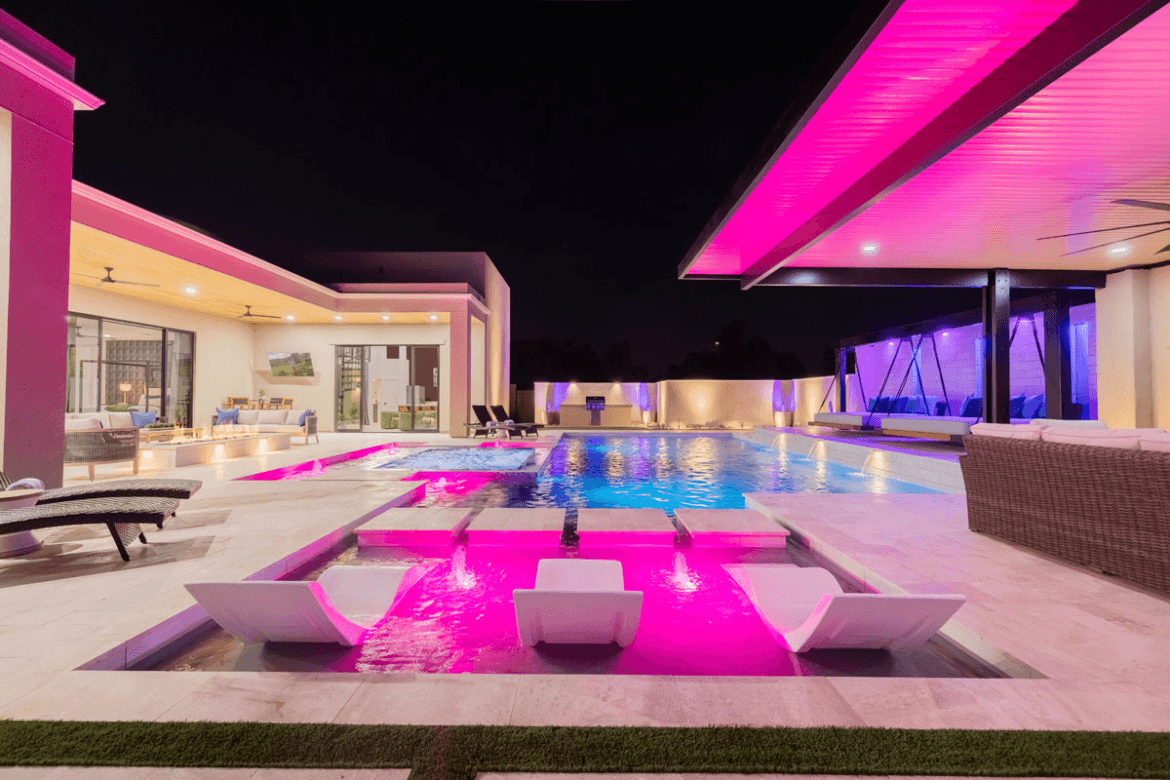 Image of the pool lit up at night.