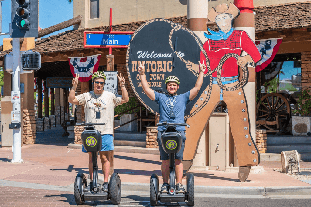 Two people pose for a picture on Segways in Historic Old Town Scottsdale.
