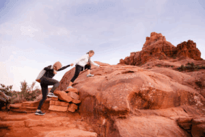 Women hiking through the red rock formations of Sedona, Arizona.