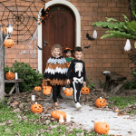 Kids in Halloween costumes trick or treating.