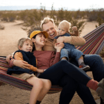 A family hanging out together on a hammock.