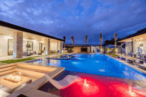 A backyard oasis with large swimming pool and lounge area.