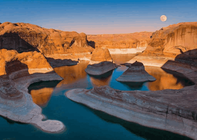 An image of the moon rising over Lake Powell and Glen Canyon.