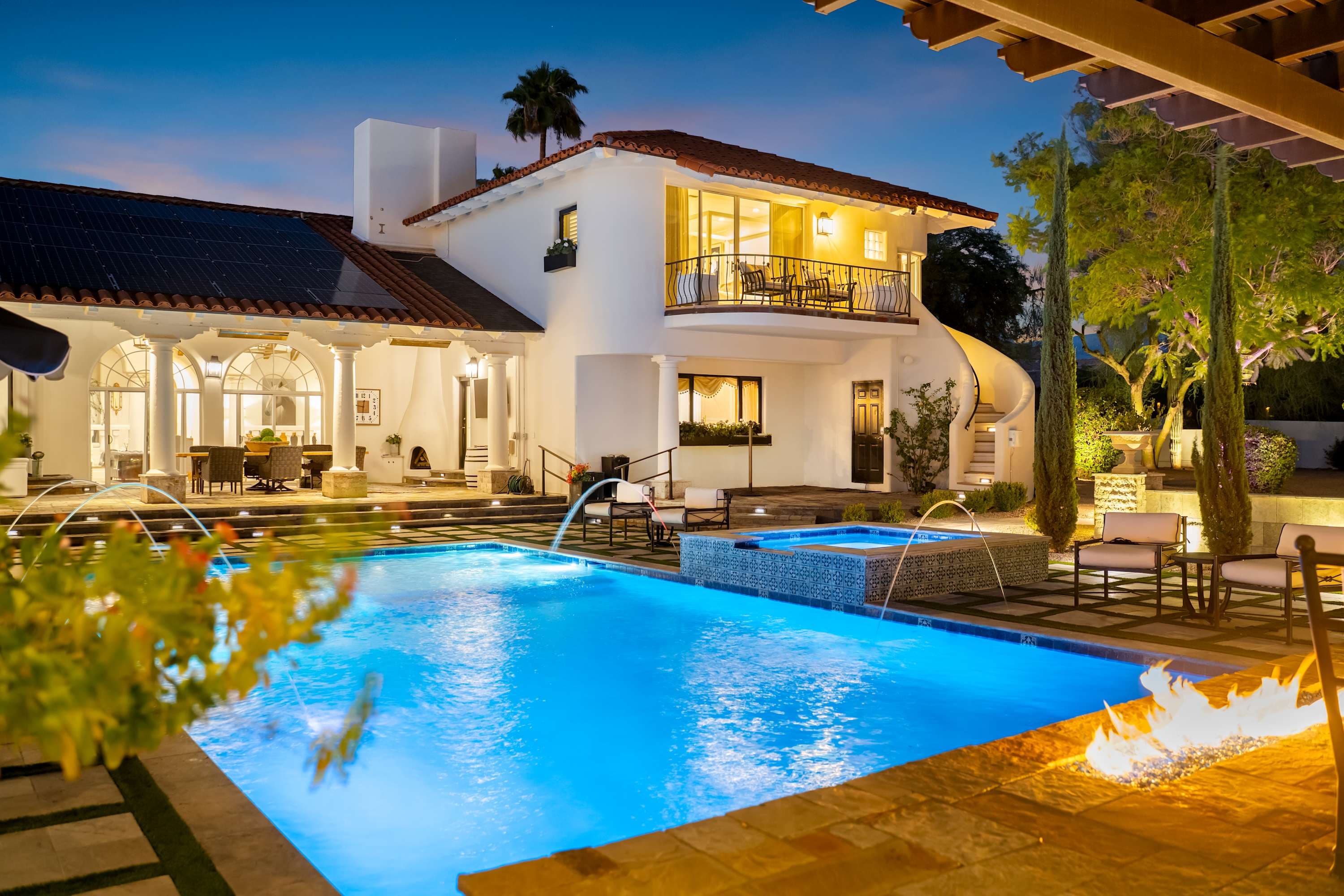 Experience vibrant nights; glowing waters meet a warm hearth.
