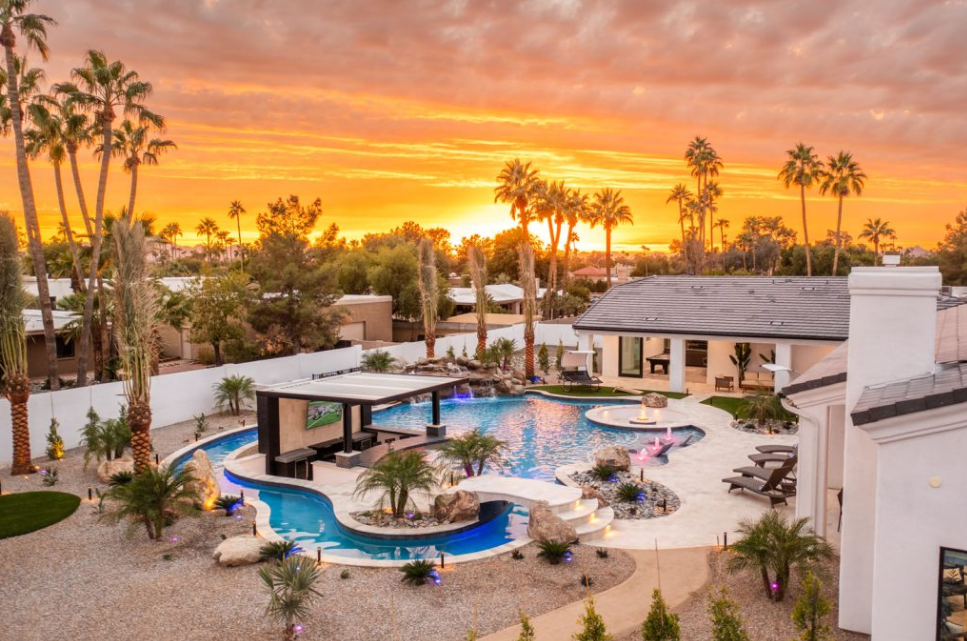 A luxury mansion rental with a lazy river pool in the backyard. 
