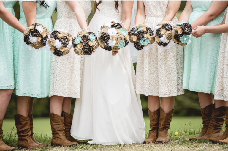 A bride and her bridesmaids in white and mint dresses.