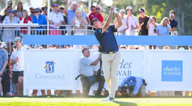 Golfer swings during the Charles Schwab Championship with spectators watching.