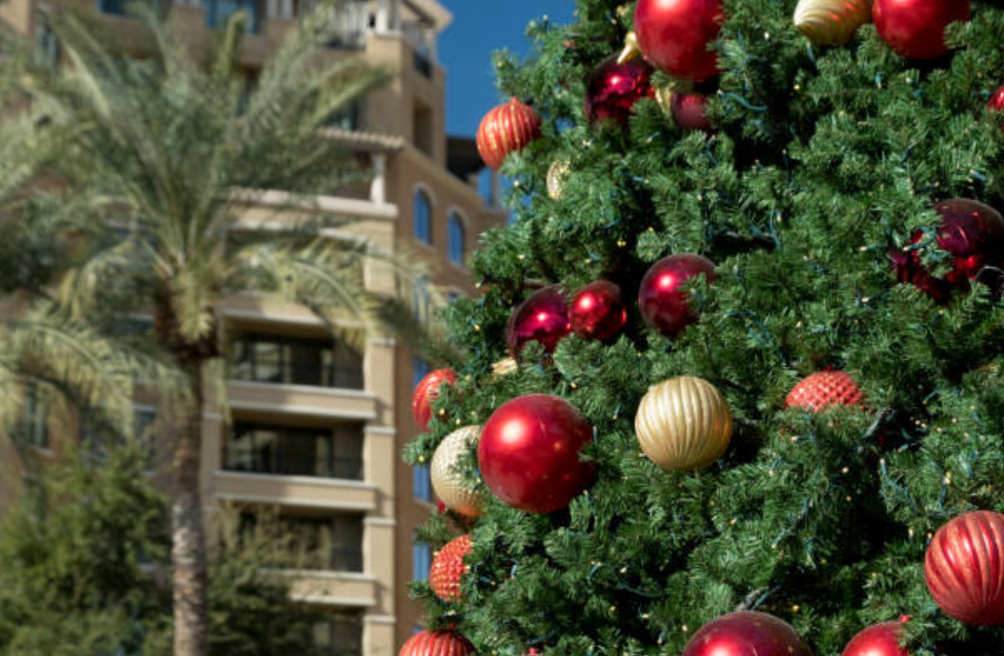 Christmas tree with ornaments in Scottsdale, Arizona surrounded by palm trees and resorts.