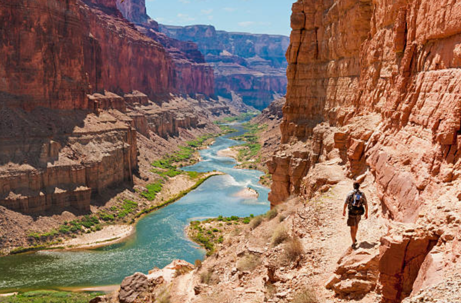 Hiker exploring the Grand Canyon on an adventure tour in Arizona.