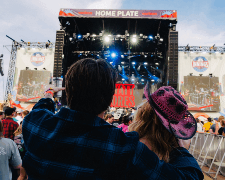 Couple enjoying live music at the Innings Festival main stage.