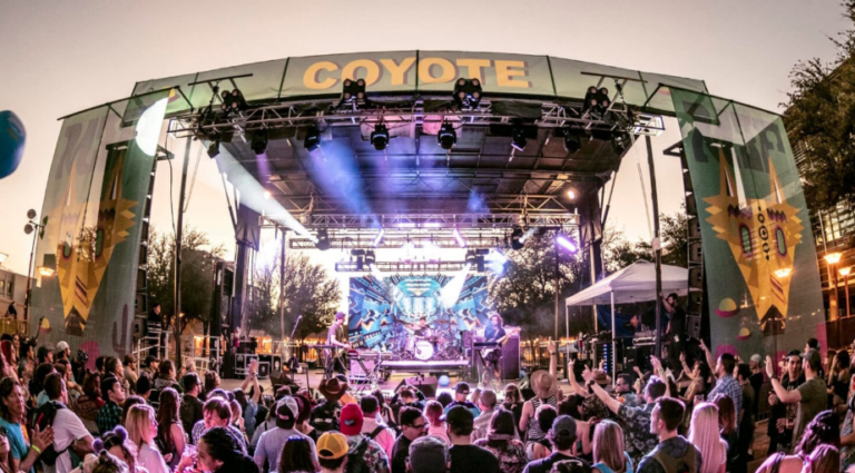Crowd watching a live band perform on the Coyote stage at M3F Festival.