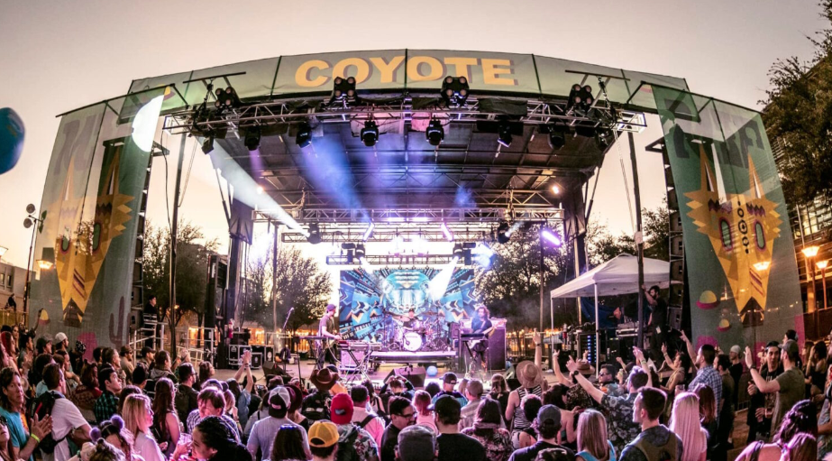 Crowd watching a live band perform on the Coyote stage at M3F Festival.