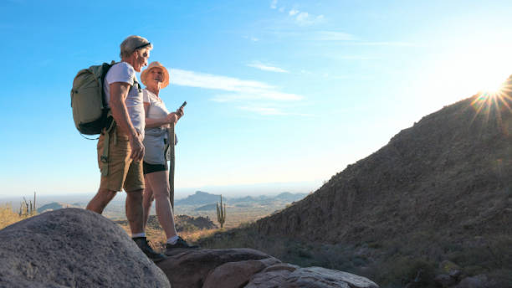 An image of a man and woman hiking in the desert