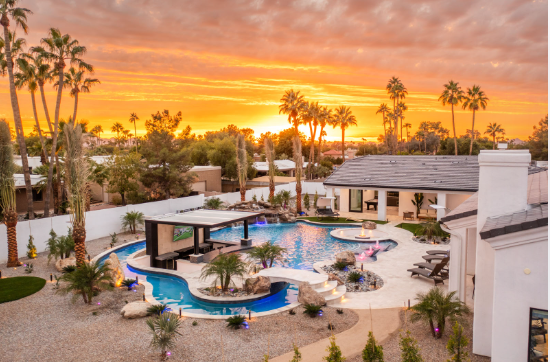 A mansion with a resort style pool.