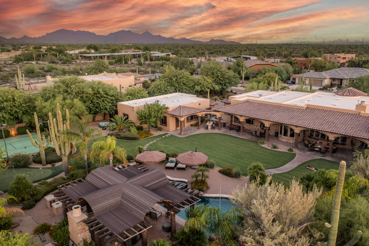 A large vacation rental in the desert with a large backyard.