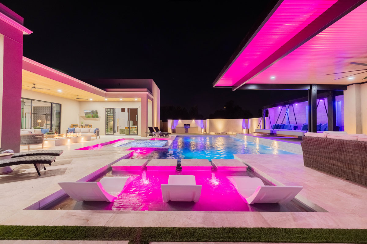 Image of the pool lit up at night.