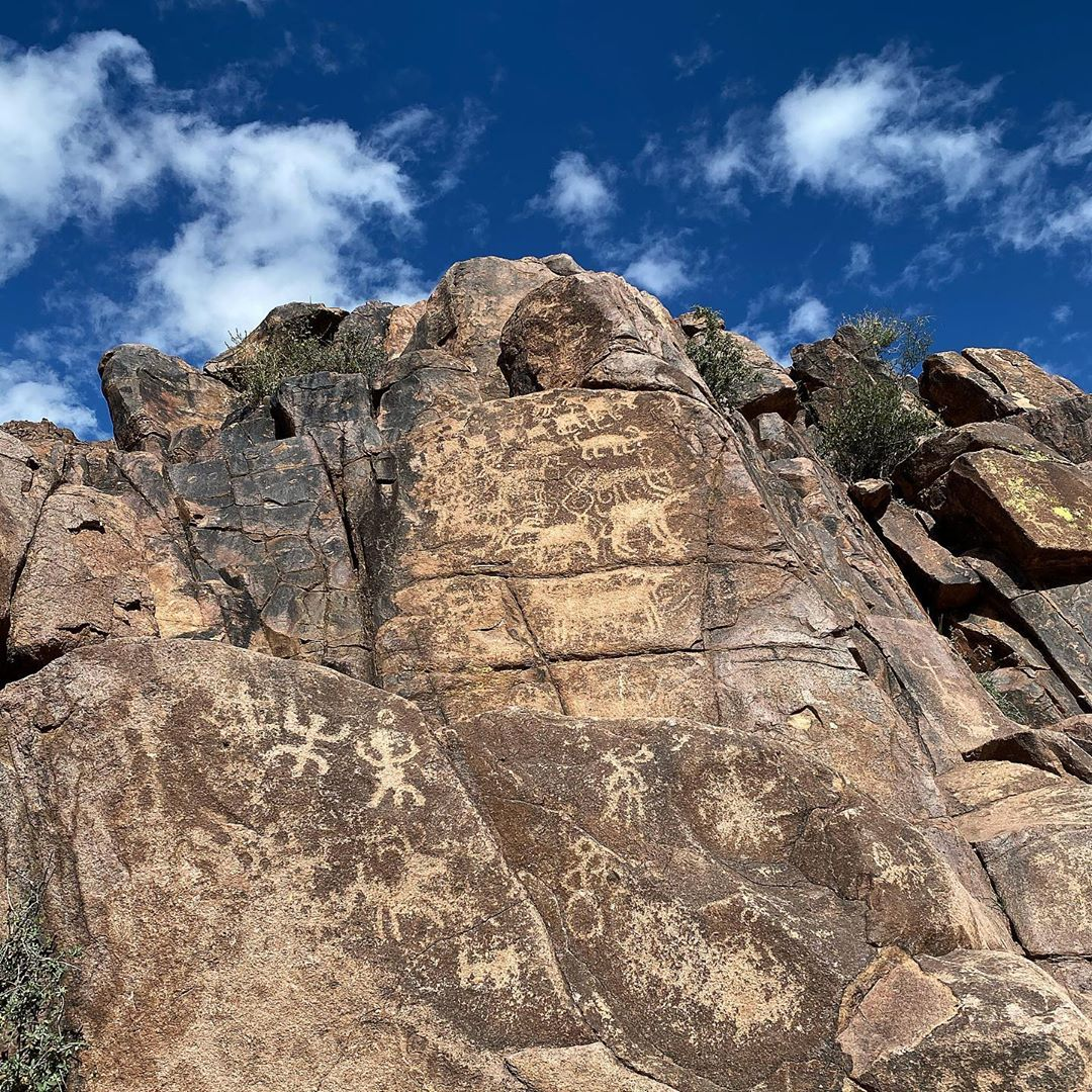 Ancient petroglyphs on a rock wall. 