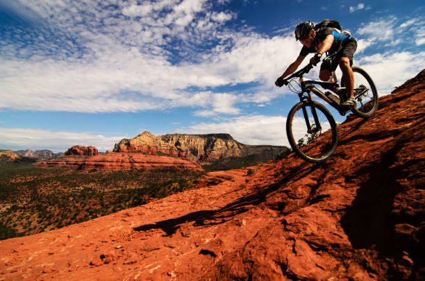 Mountain biker tackling rugged red rock trails in Central Arizona.