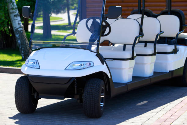 White multi-seat golf cart parked outdoors.