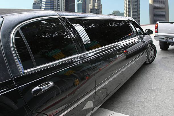 A sleek black limousine parked and ready to pick up passengers. 