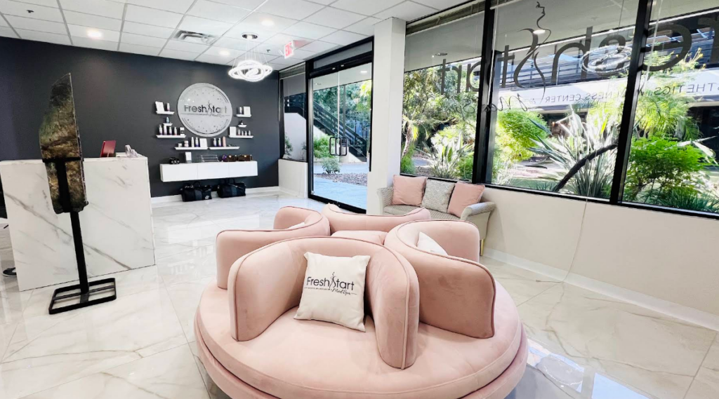 The bright, modern lobby of Fresh Start Med Spa features soft pink seating and floor-to-ceiling windows.