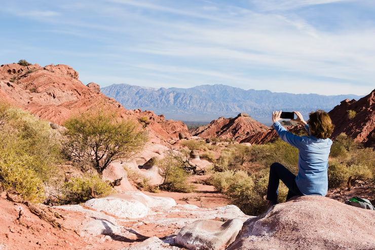A woman takes a selfie in the desert.
