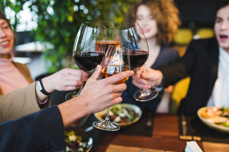 An image of a group of friends toasting wine glasses. 