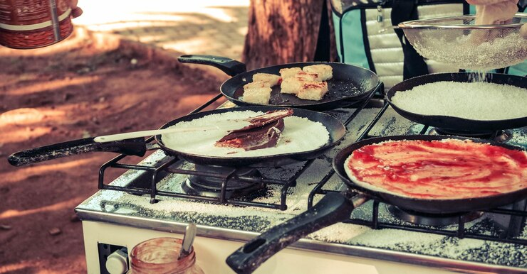 An image of various Mexican dishes on an open stove. 