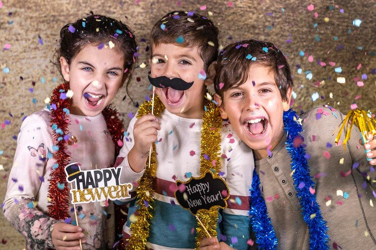 Three kids celebrate New Years Eve.