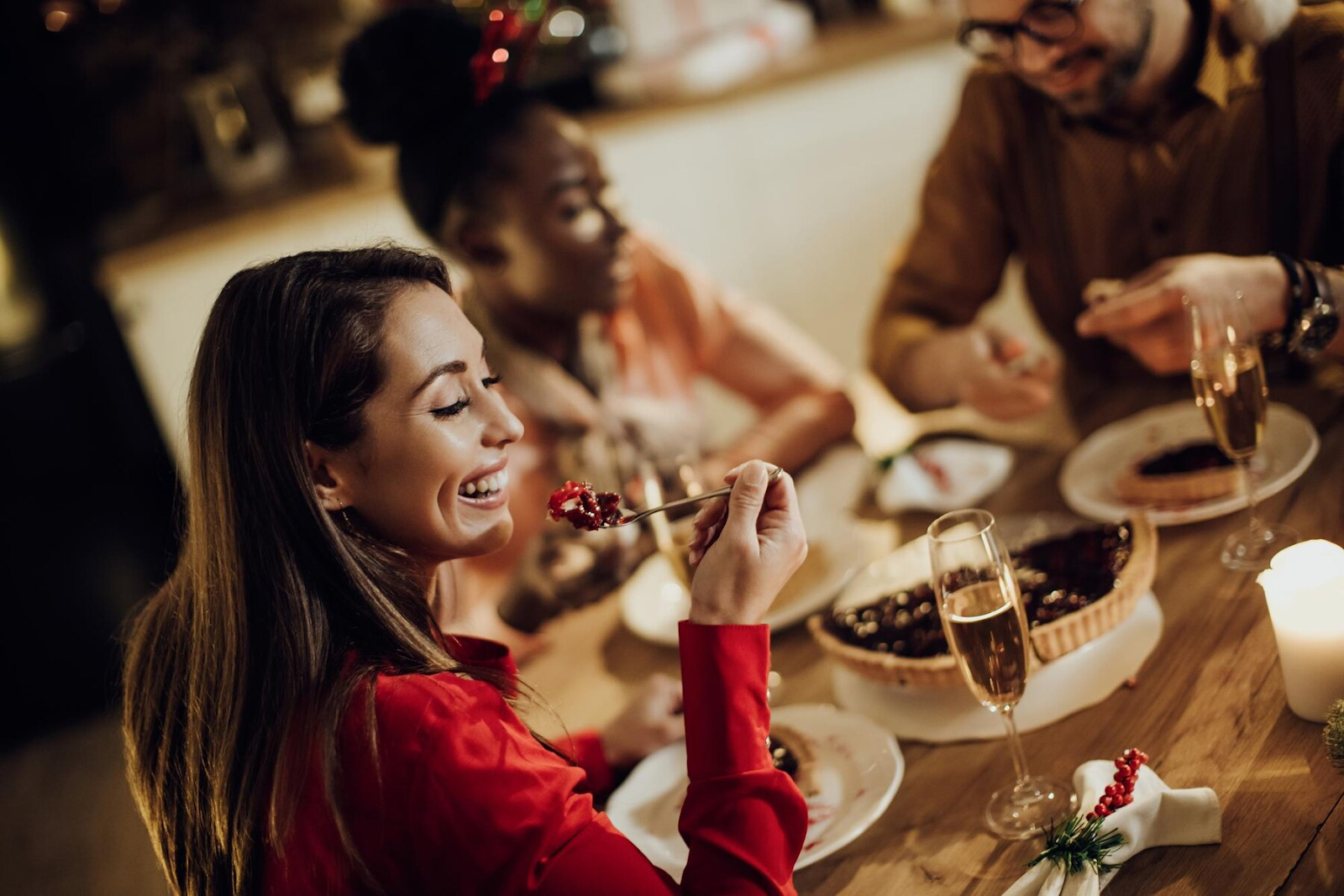 A woman enjoys dinner with friends. 