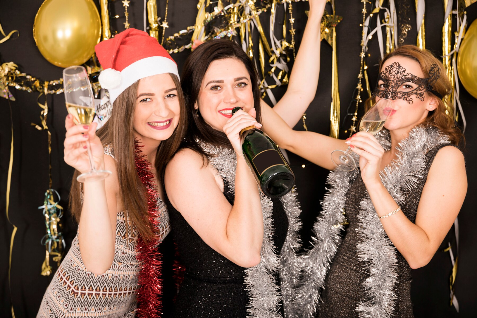 Three women enjoy celebrating New Years Eve.