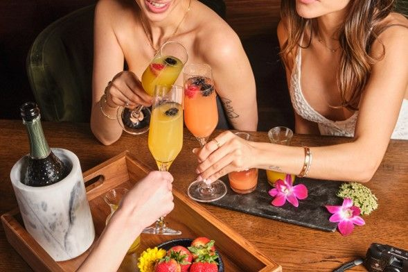 A group of friends having a toast at Toca Madera.