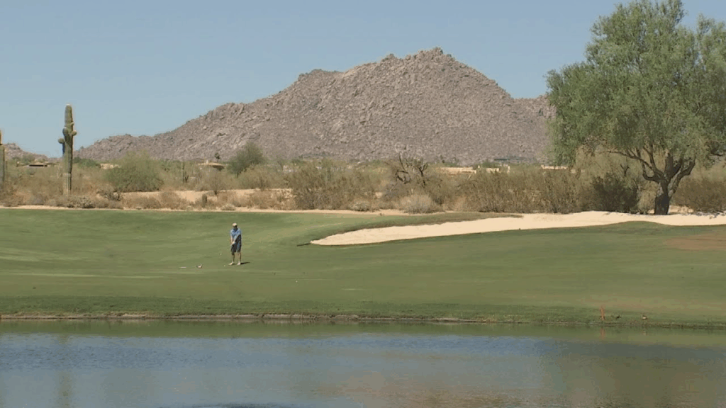 Grayhawk Golf Club - A golfer by water at one of the golf courses in Scottsdale Arizona.