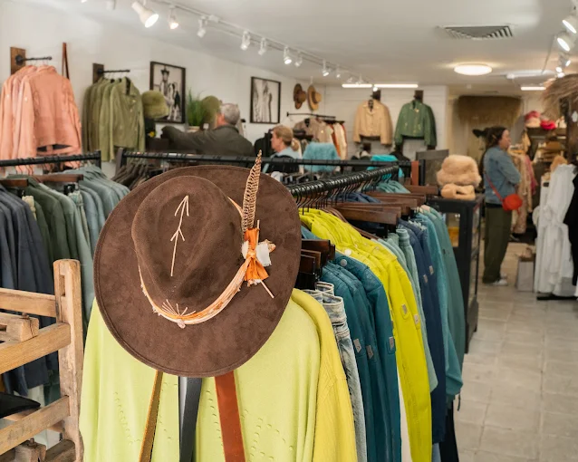 An image of a rack of clothing inside Conscious Coterie. 