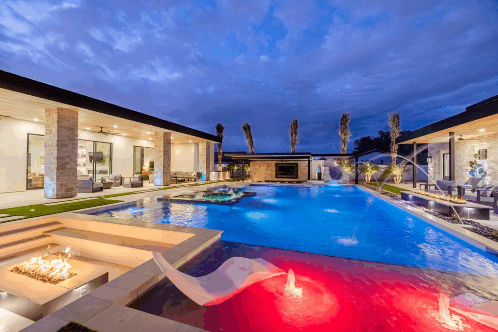 A backyard oasis with large swimming pool and lounge area. 