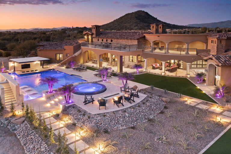 An aerial view of the backyard with a hot tub and resort style pool. 