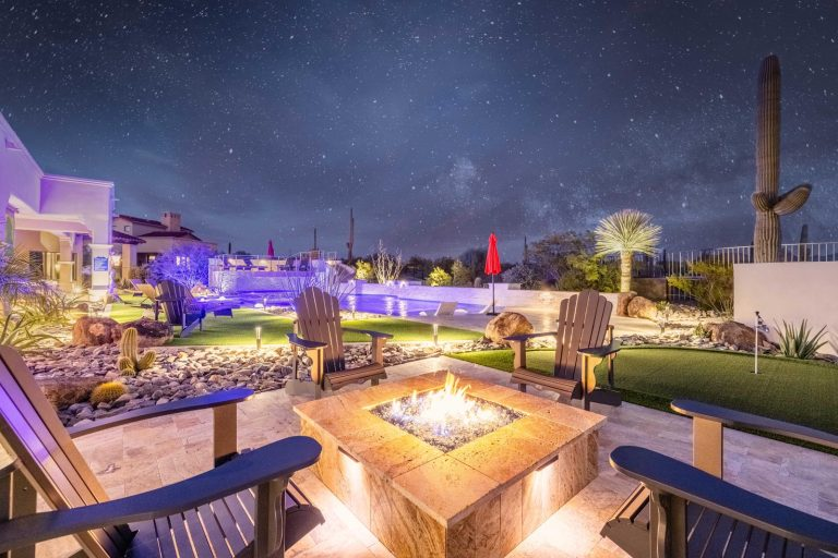 An image of a resort style getaway with a fire pit, pool and putting green. 