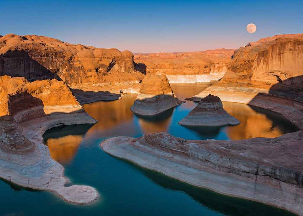 An image of the moon rising over Lake Powell and Glen Canyon. 