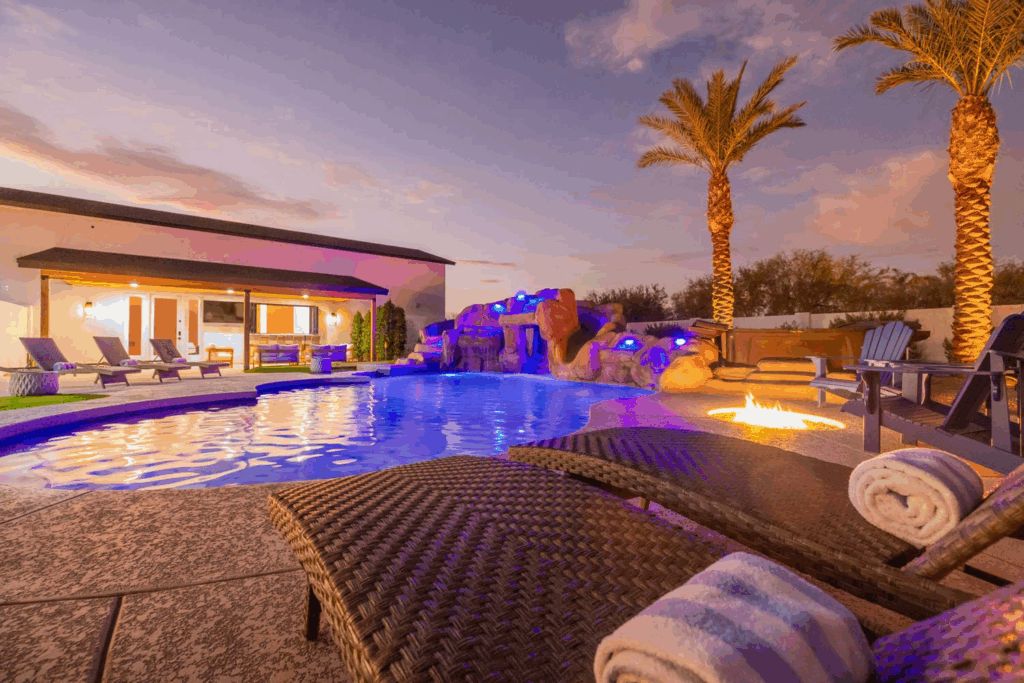 Scottsdale villa with night-lit pool and firepit.