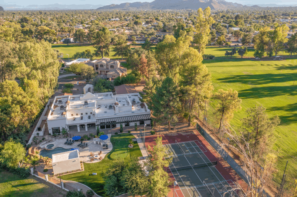 An aerial view of the mansion with a golf course.